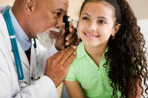 Physician examining young girl